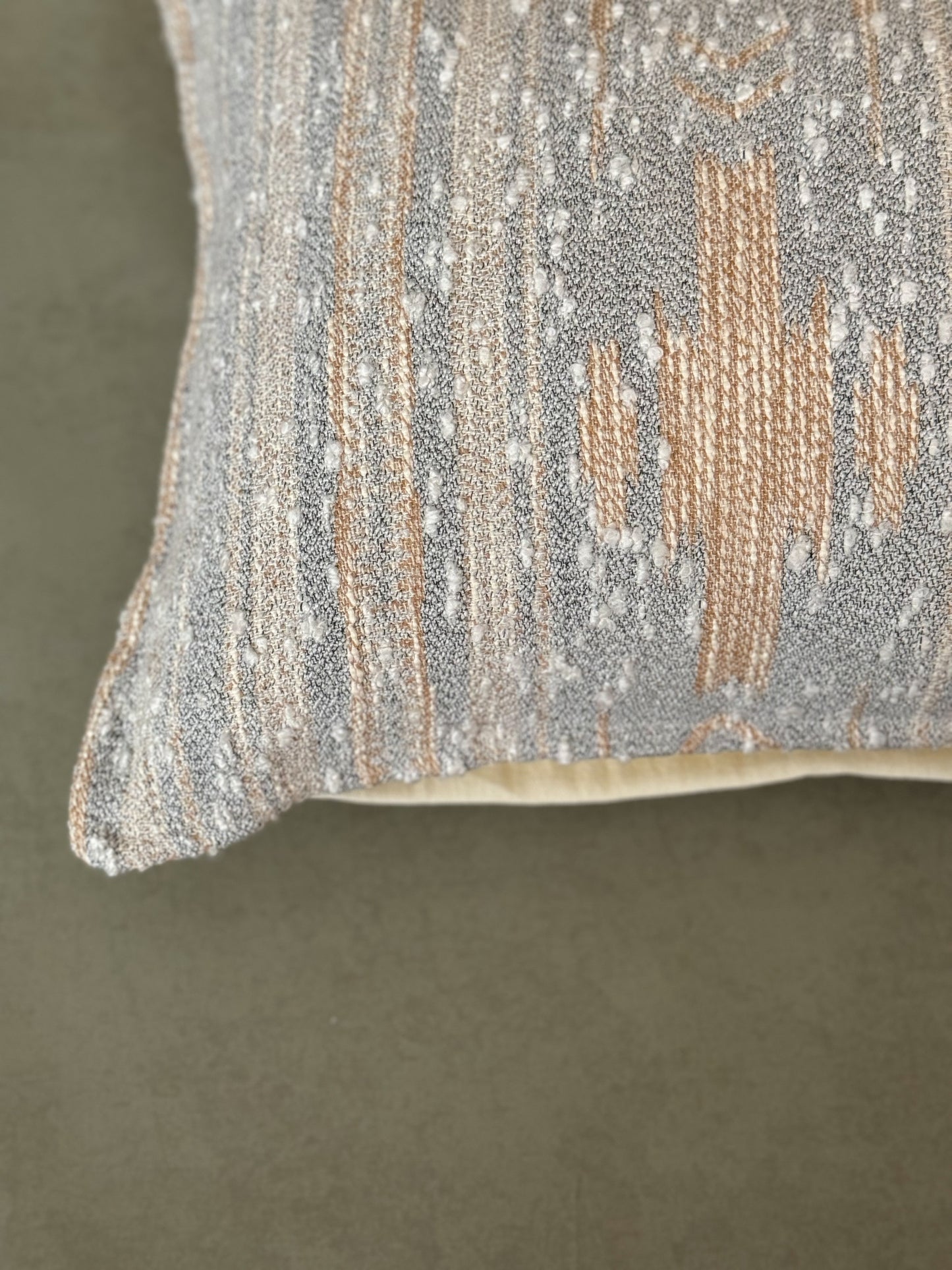 Close up of a grey decorative cotton oblong cushion to be styled on sofa,chair or bed.
