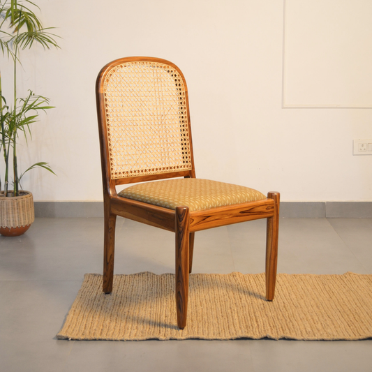 Wooden chair with wicker backrest and seat.
