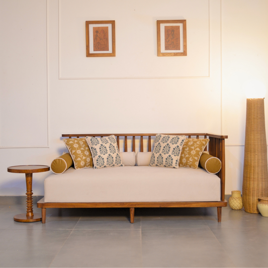 Wooden sofa with patterned cushions in a minimalistic room.
