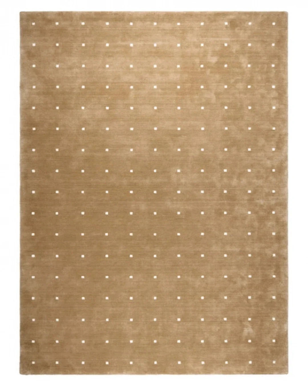 Beige rug with white polka dot pattern on a plain background