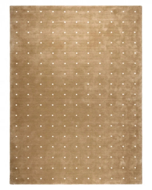 Beige rug with white polka dot pattern on a plain background