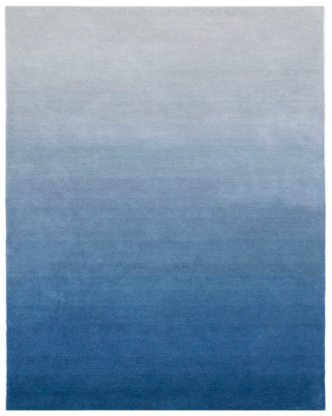 Gradient blue rug with a smooth transition from light gray to dark blue.