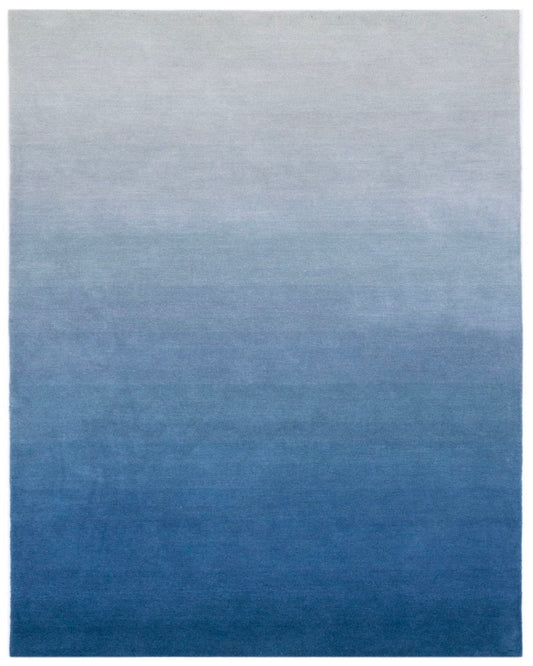 Gradient blue rug with a smooth transition from light gray to dark blue.