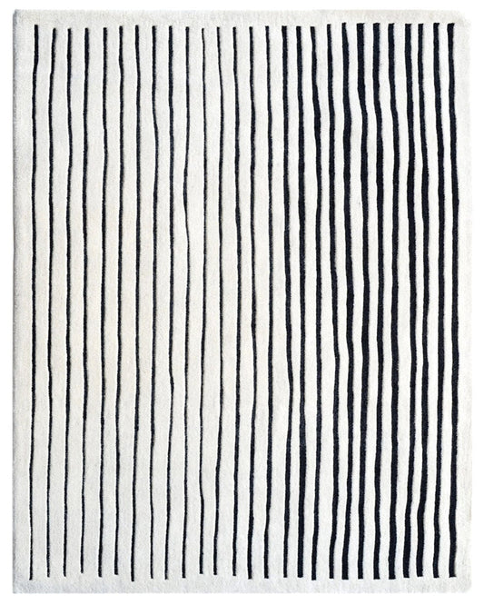 Striped black and white rug with vertical lines on a white background