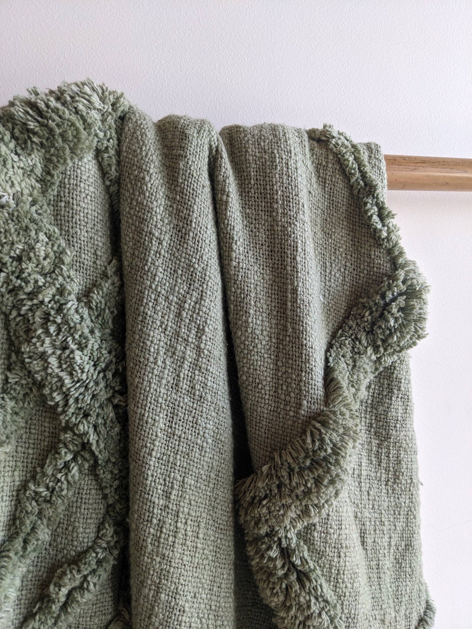 green sofa throw by Altrove