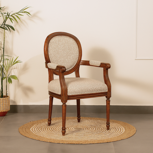Wooden chair with beige cushion with hand rest.