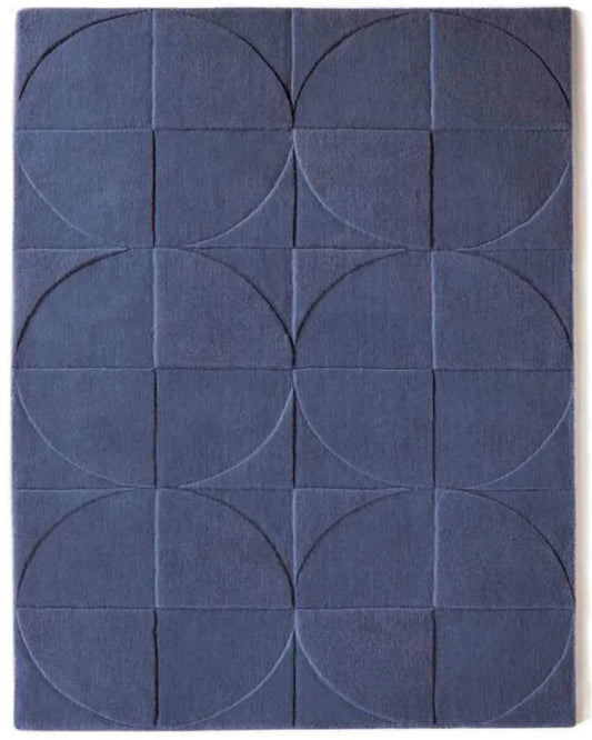 Blue geometric patterned rug with circular and square shapes