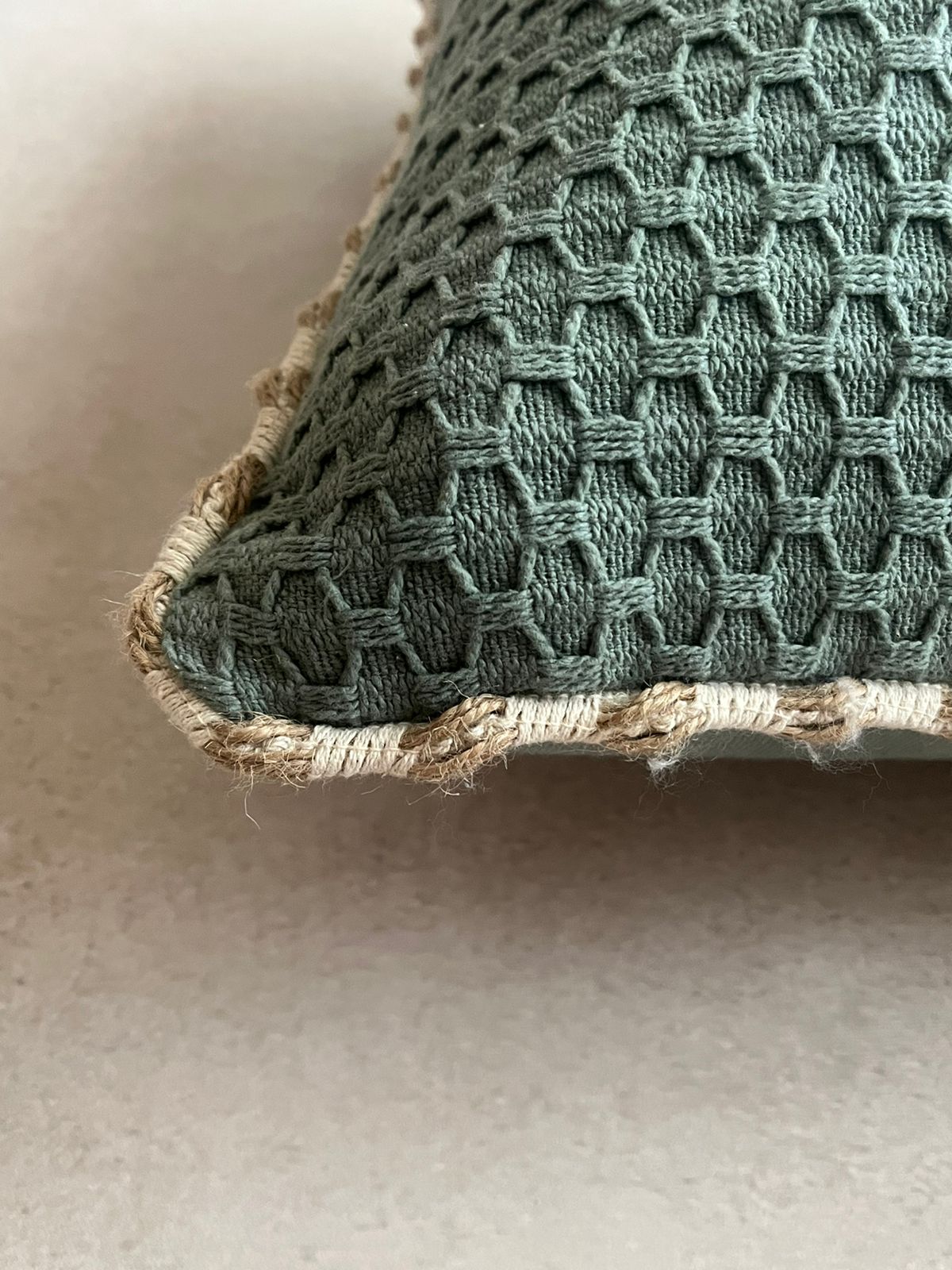 Green square cushion cover with beige piping