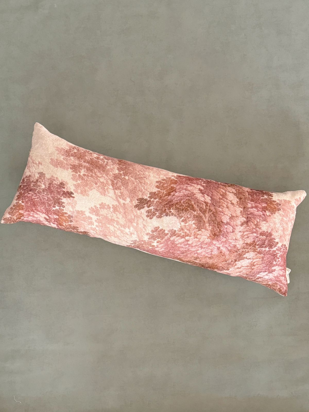 Digital printed body pillow with leafy branches in subtle brown and blush tones.