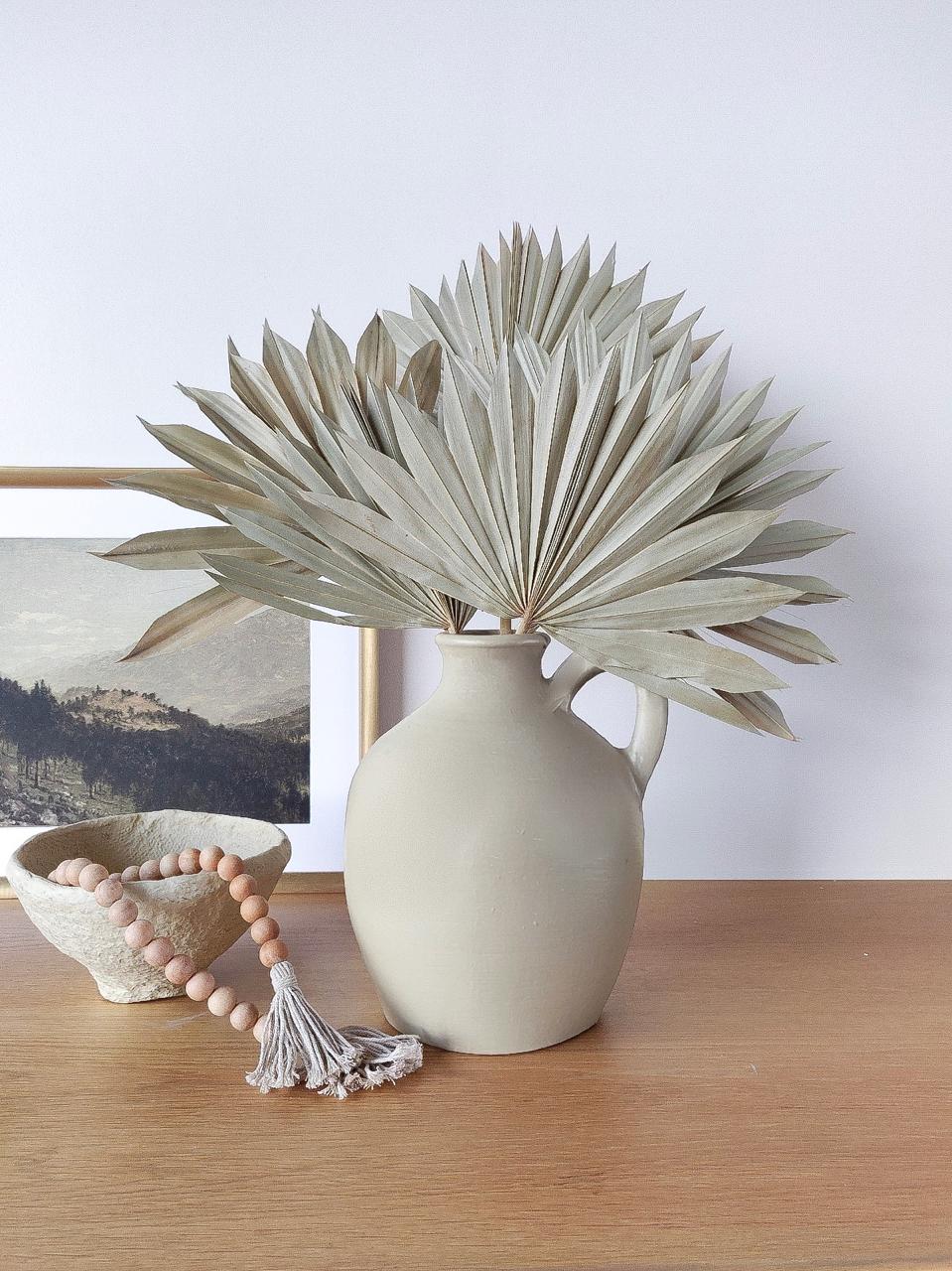 Clay vase with dried flowers