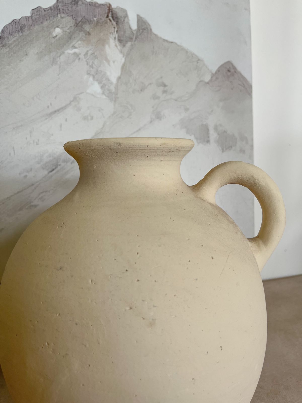 Clay vase with small mouth and handle
