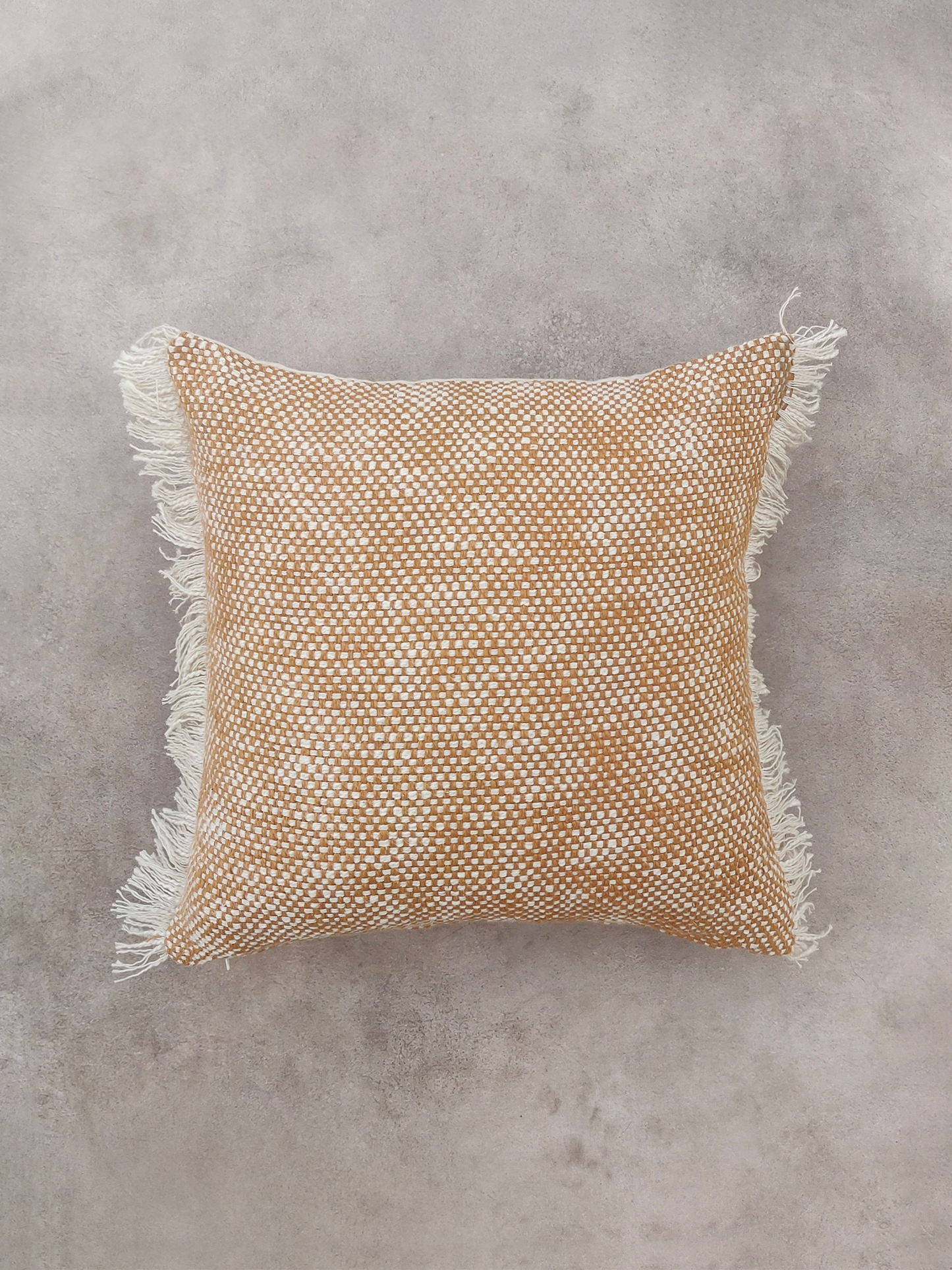 Yellow textured cushion with tassels