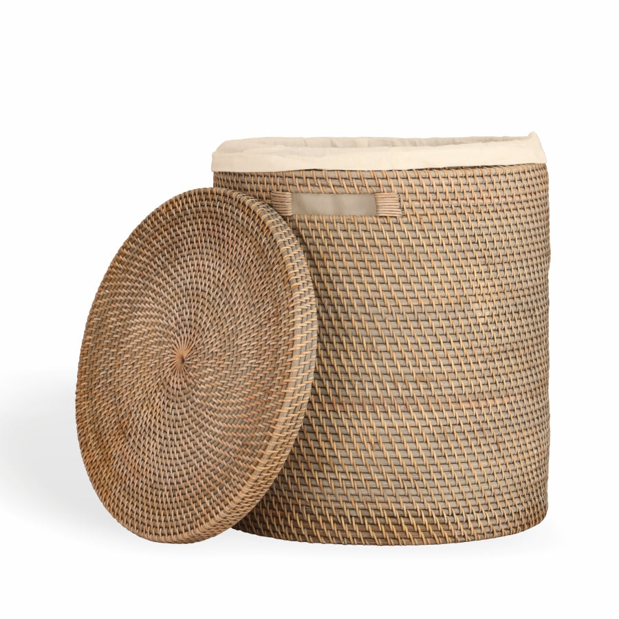 Woven laundry basket, Rattan laundry hamper, Lidded wicker laundry basket, Handwoven laundry bin, Natural wicker hamper, Round handwoven wicker laundry hamper with lid, Laundry basket with removable fabric liner, Stylish rattan laundry storage with lid. 