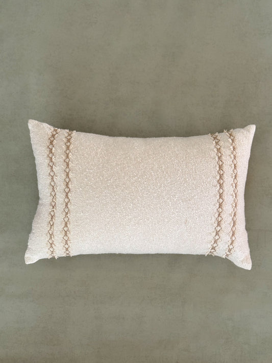 Textured ivory oblong cushion with decorative lace.