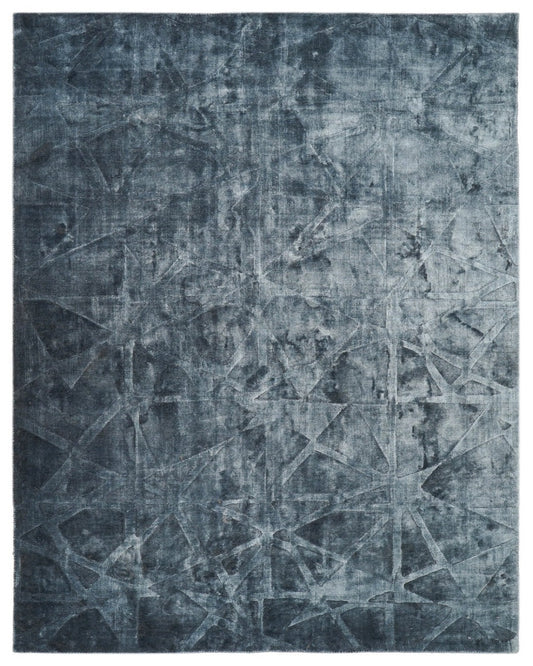 Abstract patterned rug with geometric design in blue tones