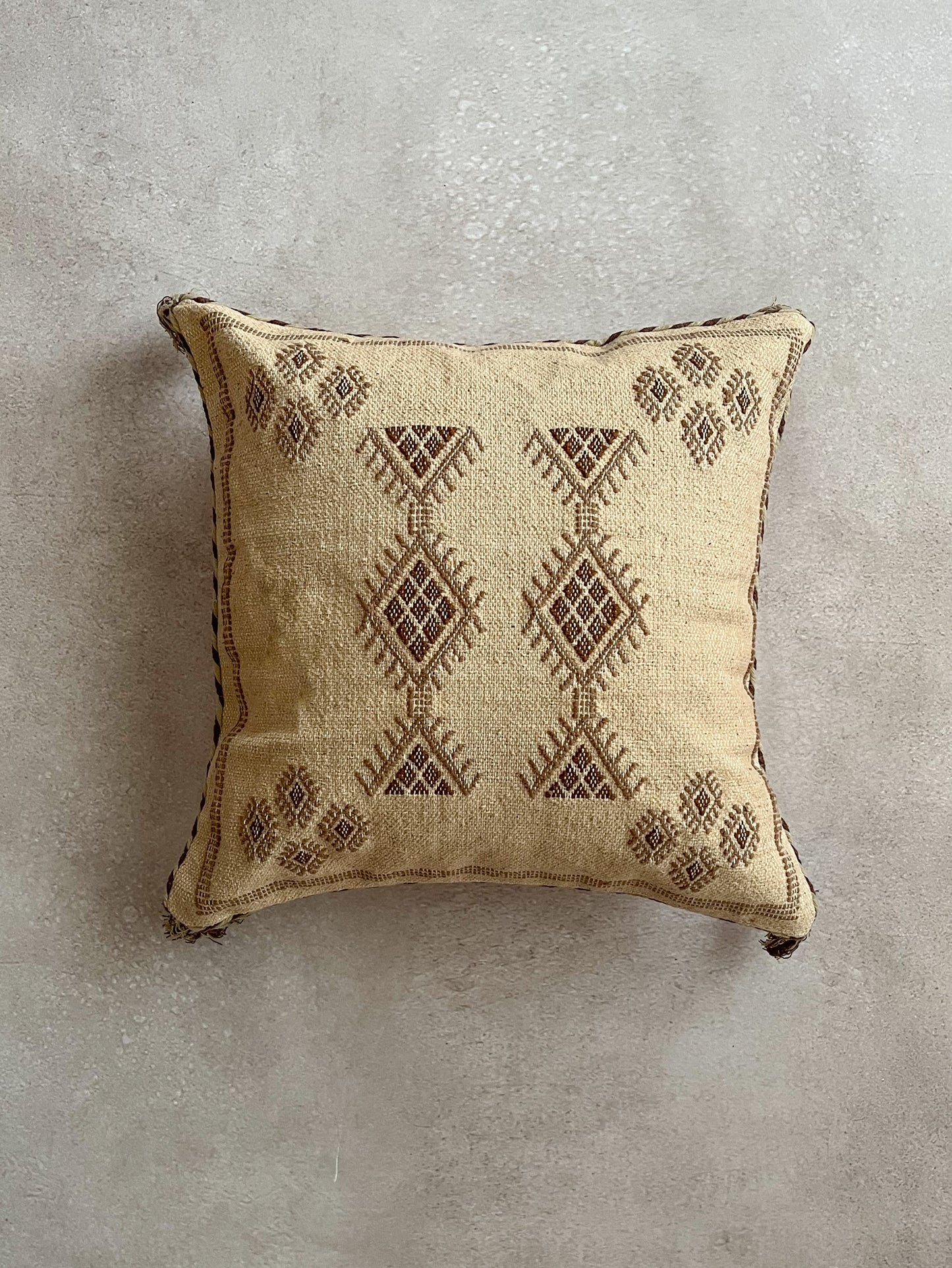 Brown colored cushion with embroidery