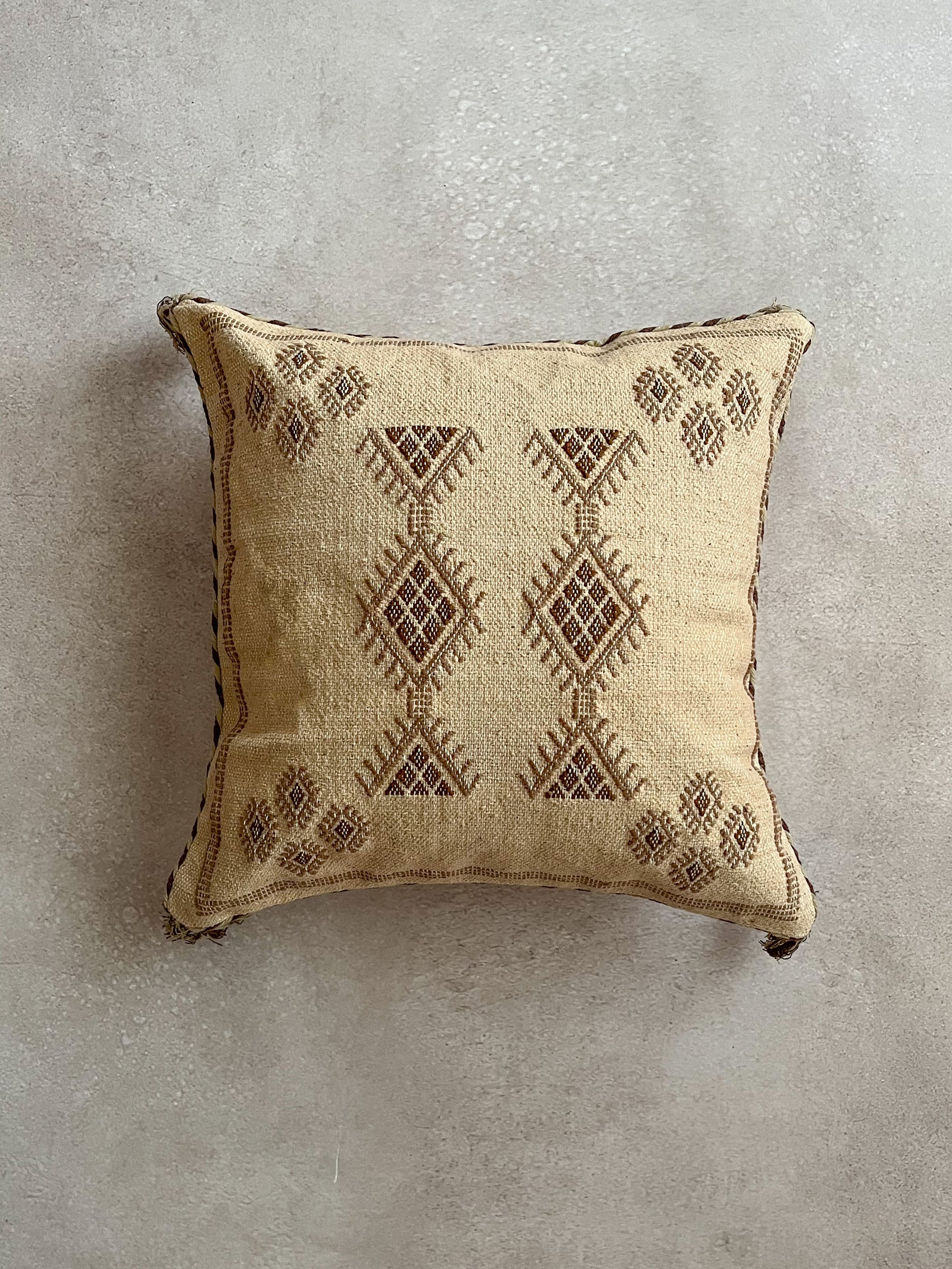 Brown colored cushion with embroidery