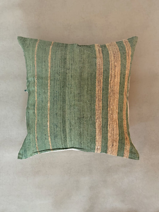 Green and beige striped pillow on a background