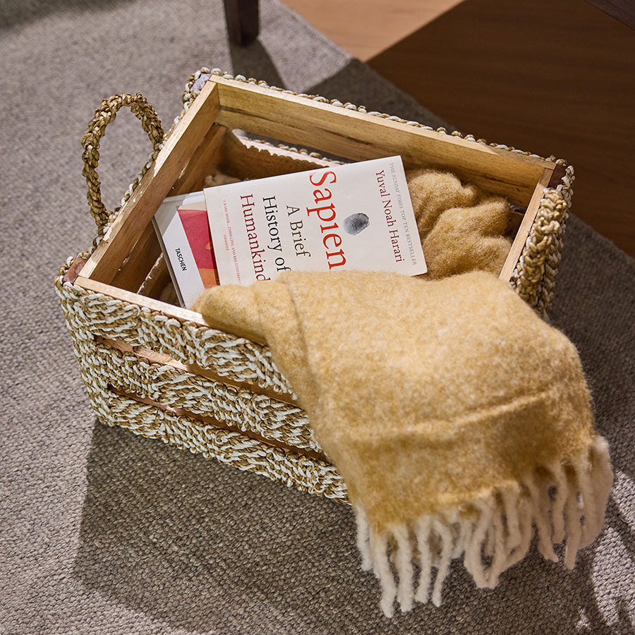 Woven rope storage basket, Natural rope and wood crate, Cozy book and blanket basket, Handcrafted woven organizer, Eco-friendly rope basket, 
Rustic wood and rope storage bin, Floor basket for books and blankets, 
Reading corner storage solution.
