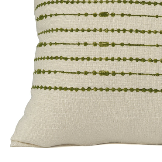 Close up of a Hand block printed green cotton cushion cover printed on an ivory base fabric
