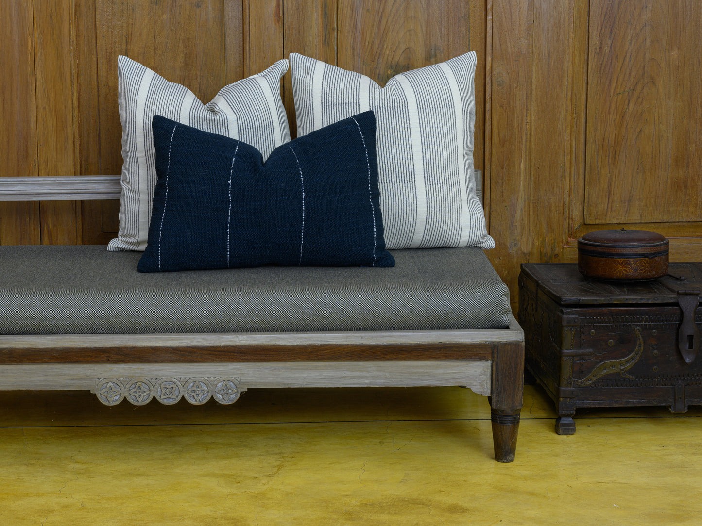 Hand woven Navy Blue cotton lumbar cushion cover styled with two Block Printed Shams on a bench